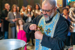Свещеникът се готви да излее светото миро във водата в купела, важна част от ритуала по кръщението на Борис. Кадър от професионален фотограф за кръщене Симеон Сълов.