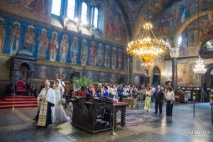 A priest leads the crowned newlyweds in the ritual procession "The Dance of Isaiah" around the lectern, symbolizing their first steps as a family. Shot by wedding photographer Simeon Salov.