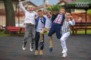 Фотограф за завършване на детска градина: Щастливи момчета-приятели скачат във въздуха, празнувайки дипломирането си. Емоционален кадър от фотограф Симеон Сълов.