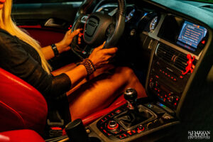 Интериорна автомобилна фотосесия в Audi S5 с модел зад волана и червен кожен салон, заснета от Симеон Сълов